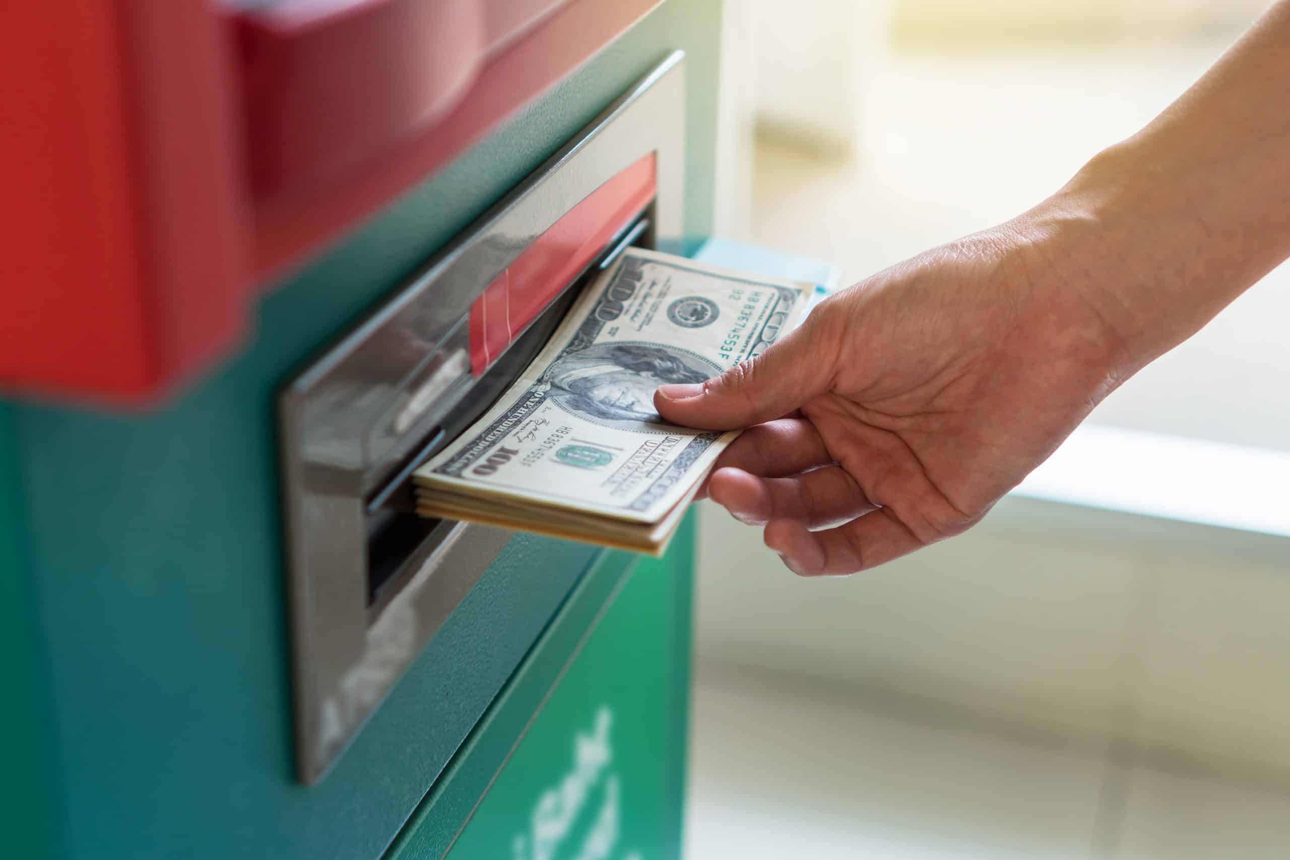 Closeup woman withdrawing the cash via ATM, business Automatic T